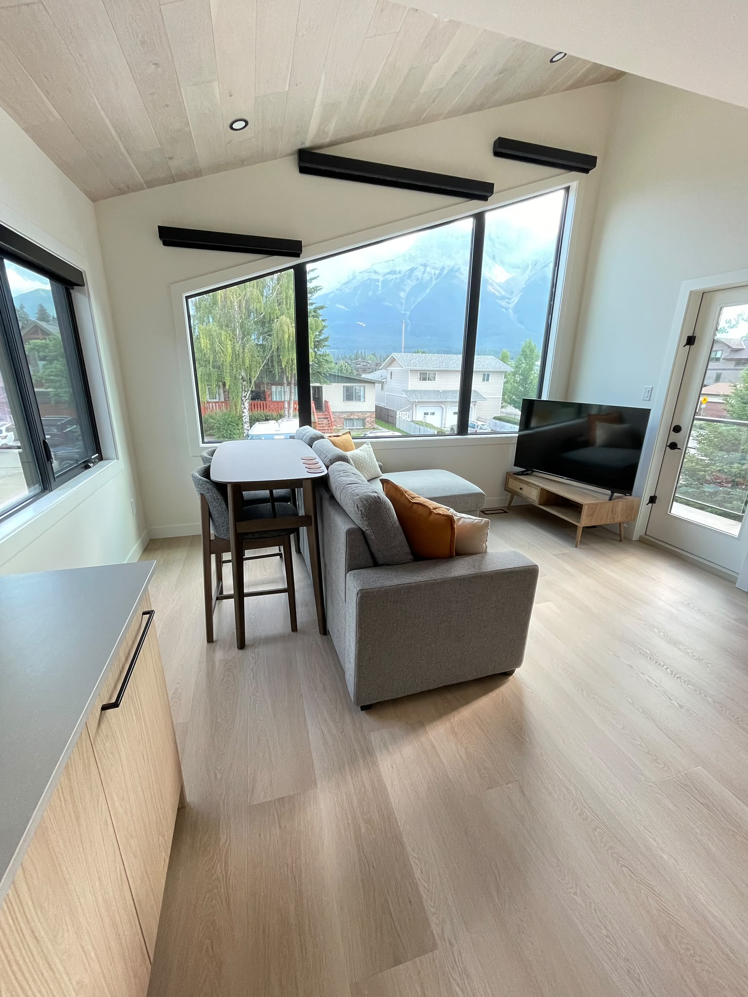 Living room with vaulted ceiling and mountain views